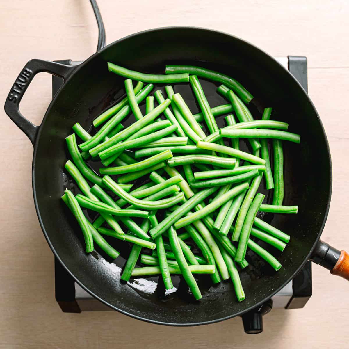 Green beans cooking in a skillet.