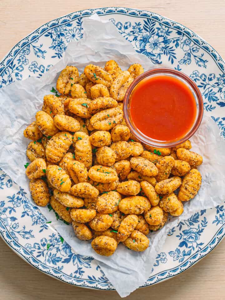 Air fryer gnocchi served in a ceramic bowl with marinara sauce.