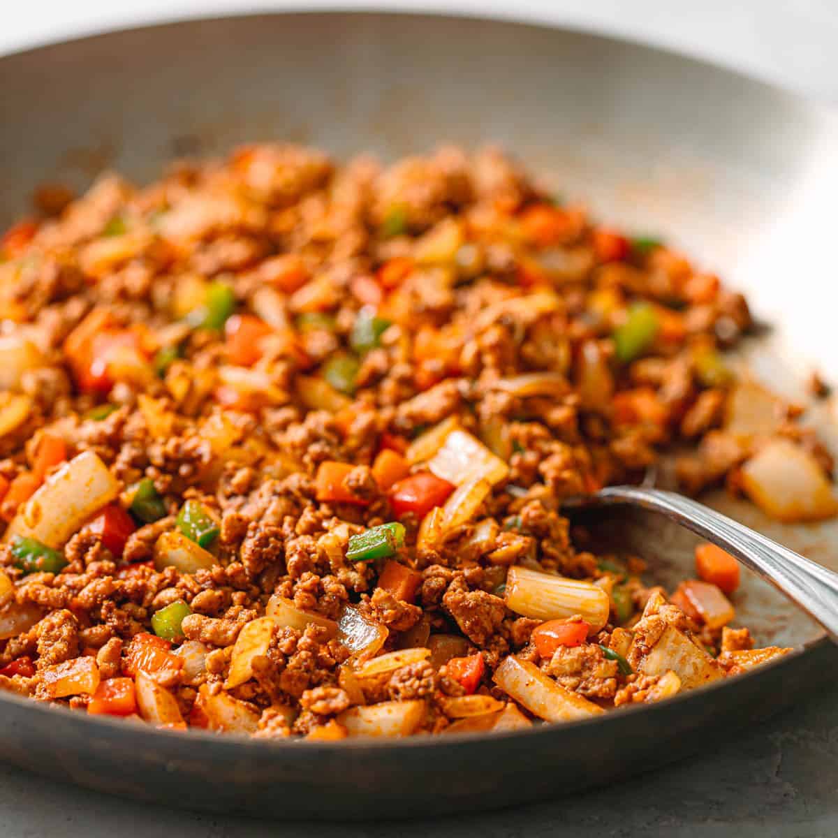 Close-up of easy ground chicken stir fry finished and ready to serve in a skillet.