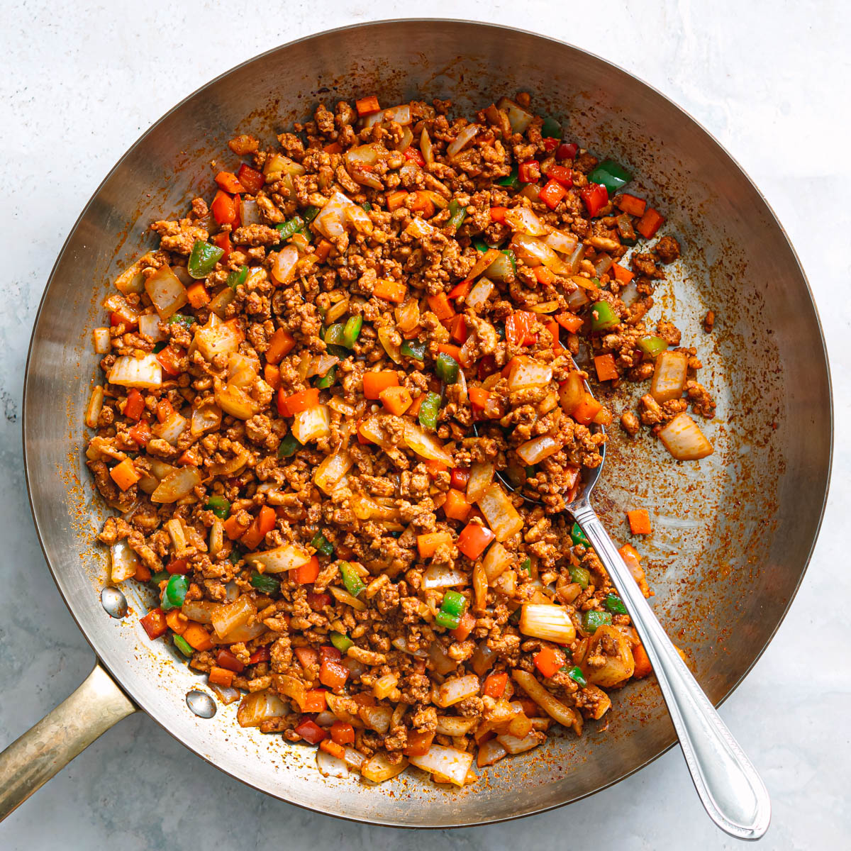 Easy ground chicken stir fry cooked and ready to serve in a large skillet.
