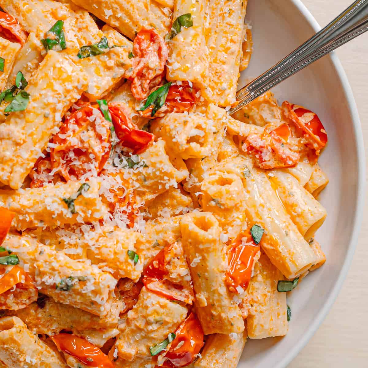 easy baked Boursin tomato pasta recipe with cherry tomatoes and rigatoni in ceramic bowl
