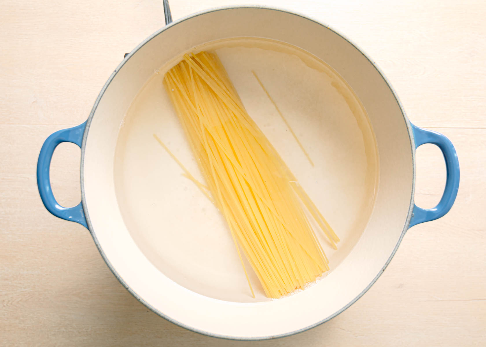 Cooking spaghetti in a large pot of salted boiling water for pasta puttanesca recipe.