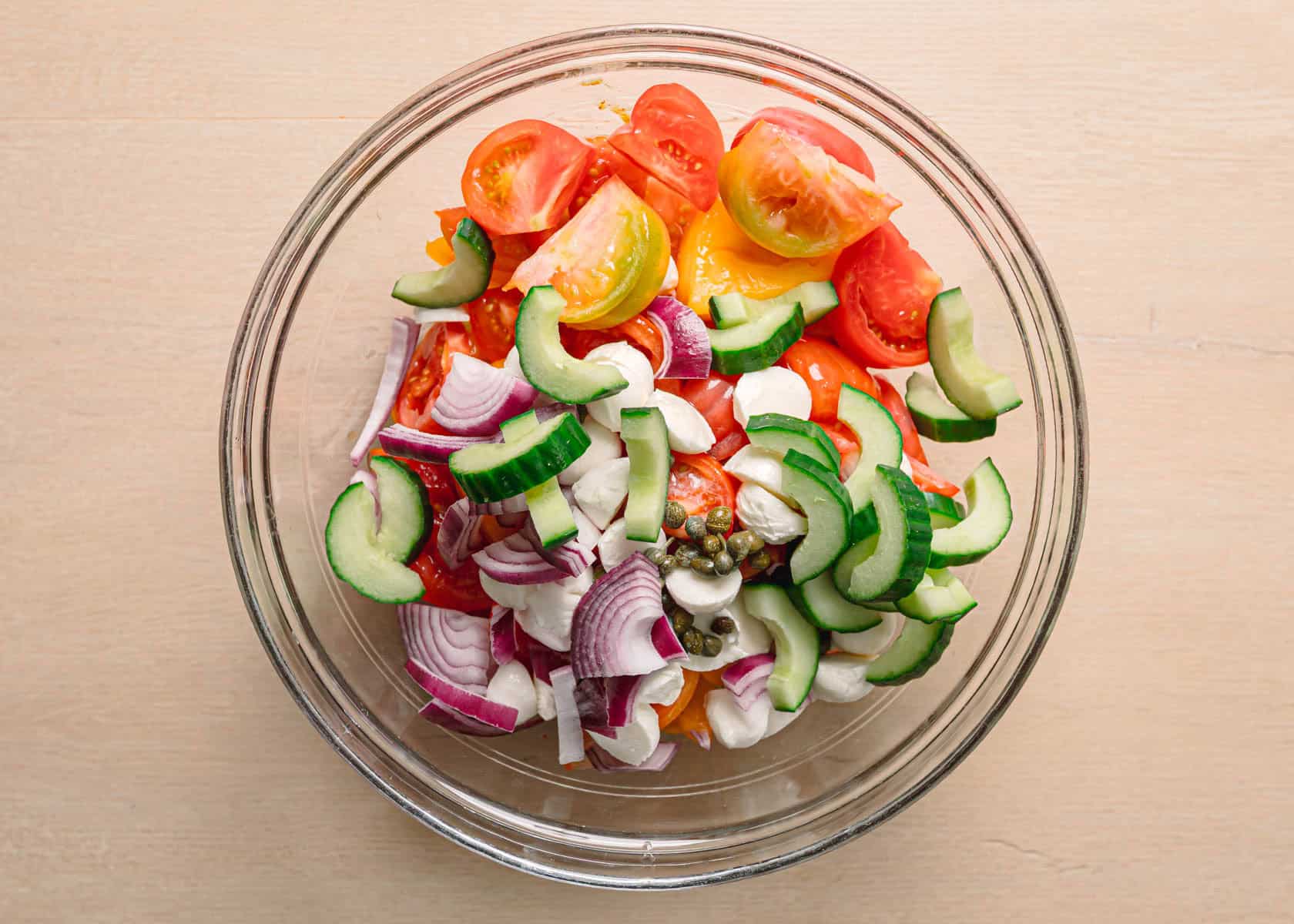Easy panzanella salad recipe chopped heirloom tomatoes cucumber and red onion.