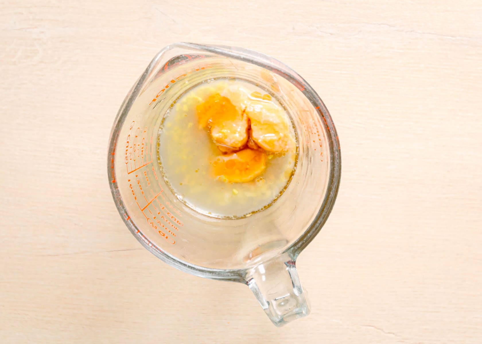 How to make homemade miso salad dressing by whisking white miso, honey, lime juice, and garlic in a bowl.