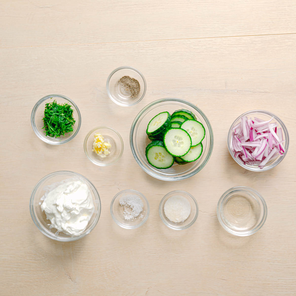 Cucumber, sour cream, fresh dill, garlic, and red onion for cucumber dill salad