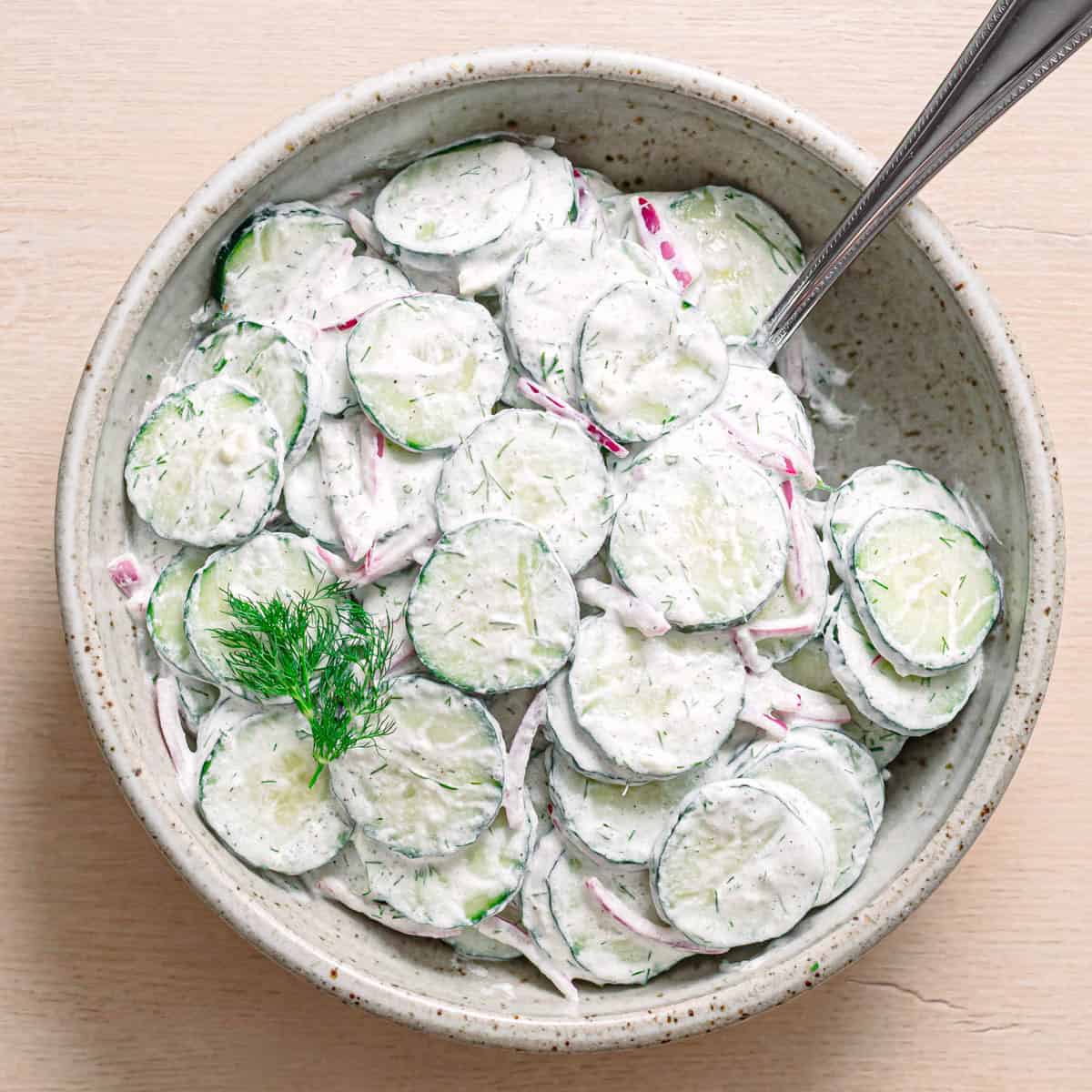 Easy cucumber dill salad recipe served in a ceramic bowl.
