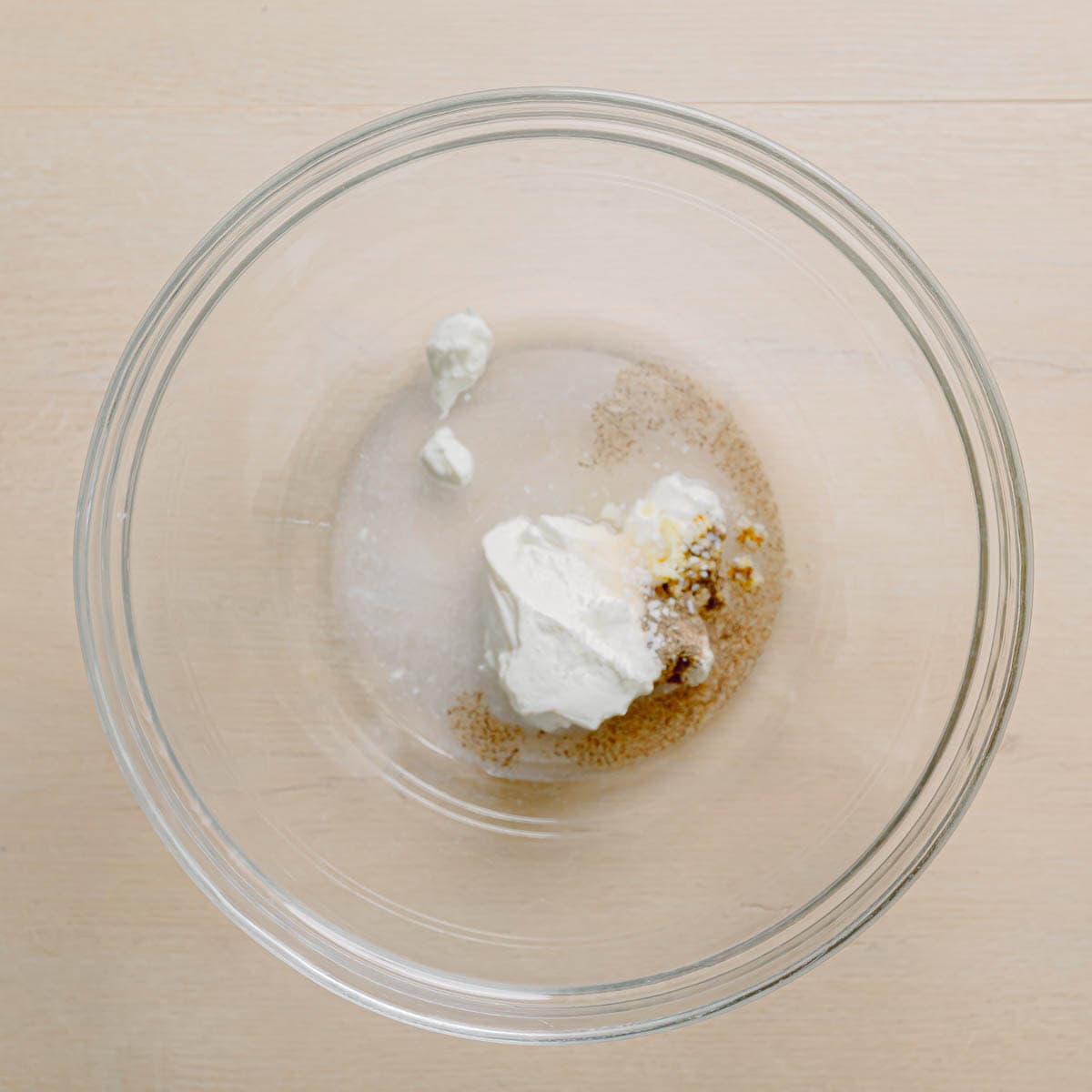 Mixing sour cream, vinegar, and dill for cucumber salad dressing.