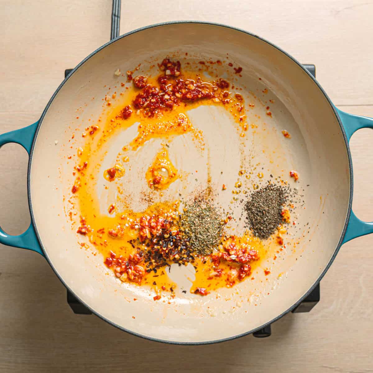 Tomato paste and herbs stirred into butter and garlic for marry me butter beans sauce.