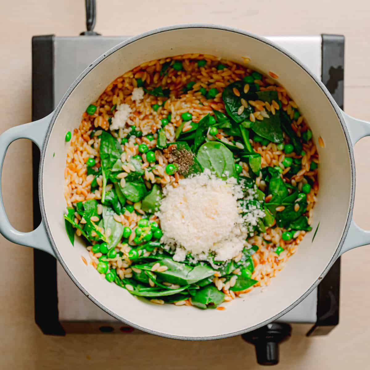 Parmesan and lemon stirred into orzo with peas.