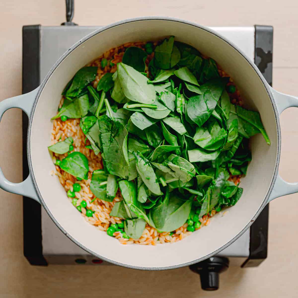 Peas and spinach stirred into cooked orzo.